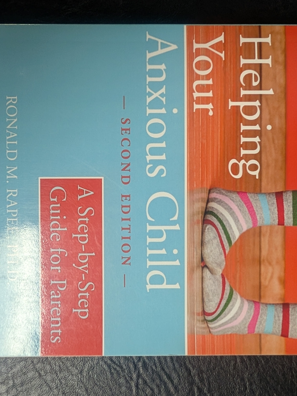 Helping Your Anxious Child - Blue & Multicolor Book Cover